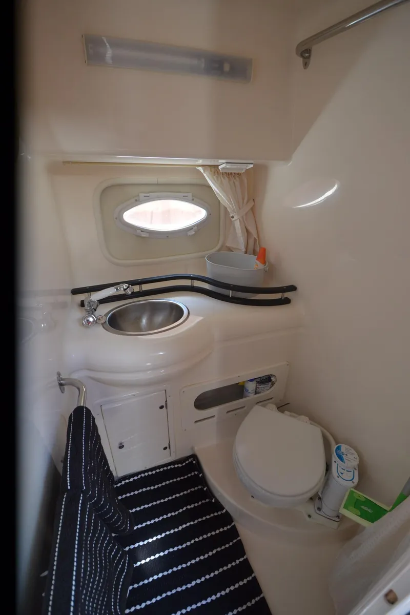 Slide: The Image of 2005 Rinker Fiesta Vee 300 EC boat bathroom with sink and toilet. - 17