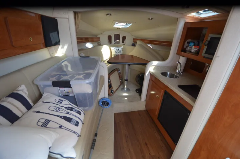 Slide: The Image of 2005 Rinker Fiesta Vee 300 EC cabin interior with kitchenette and seating area. - 18