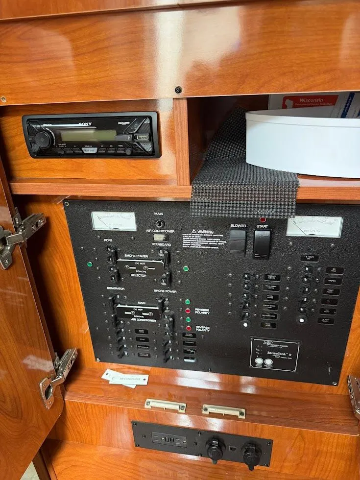 Slide: The Image of Control panel of a 2005 Rinker Fiesta Vee 300 EC boat with wood finish. - 19