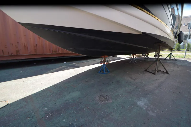 Slide: The Image of 2005 Rinker Fiesta Vee 300 EC boat on stands, underside view. - 23