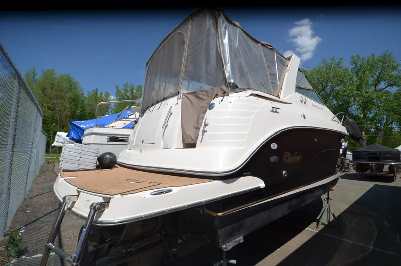 Slide: The Image of 2005 Rinker Fiesta Vee 300 EC boat docked outdoors, rear view. - 6