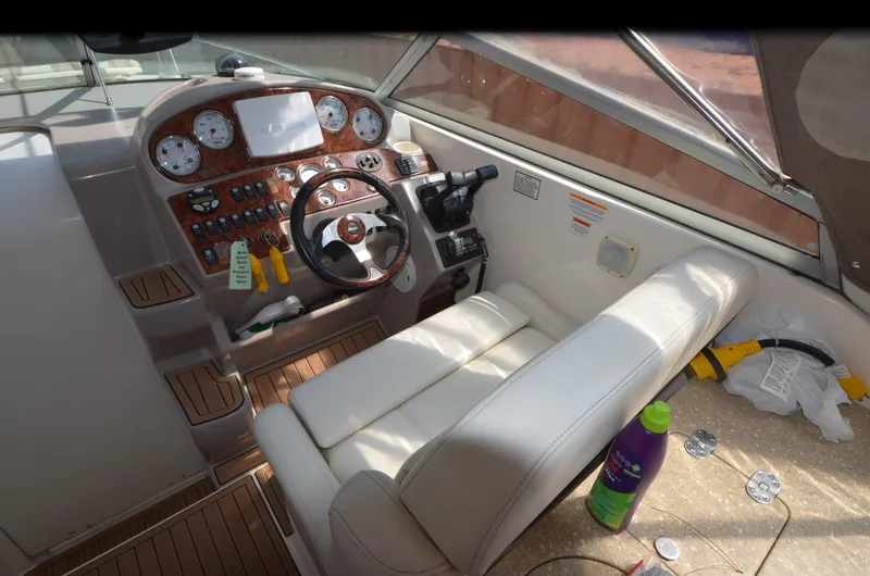 Slide: The Image of 2005 Rinker Fiesta Vee 300 EC boat cockpit with steering wheel and control panel. - 9