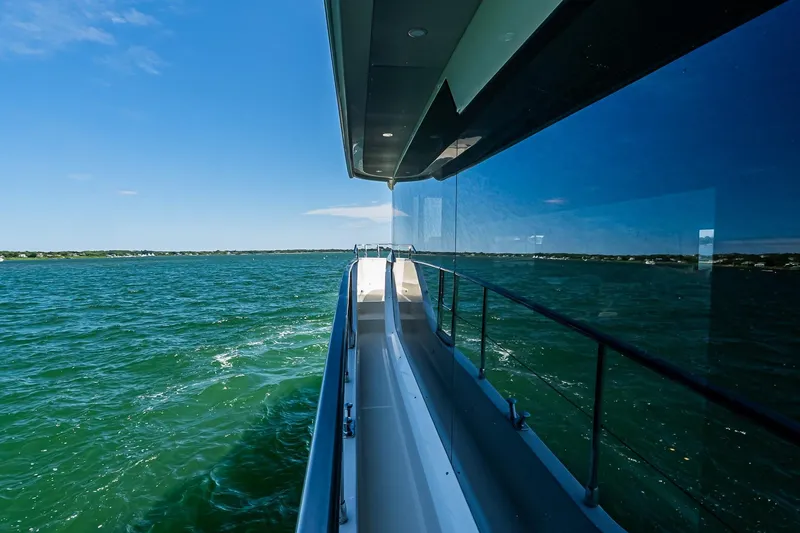 Slide: The Image of 2026 Absolute Navetta 53 yacht cruising on open water under clear blue skies. - 41
