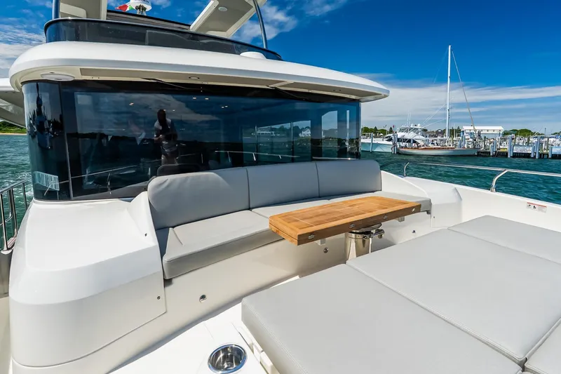 Slide: The Image of Luxurious 2026 Absolute Navetta 53 yacht with elegant outdoor seating and table. - 57