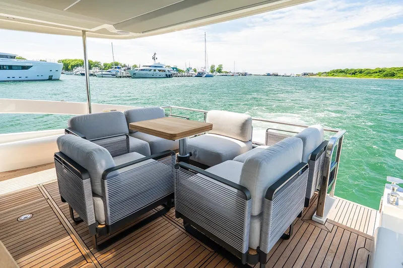 Slide: The Image of Luxurious seating area on the 2026 Absolute Navetta 53 yacht, overlooking a serene marina. - 13