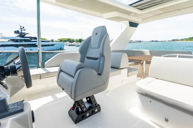 Slide: The Image of 2026 Absolute Navetta 53 yacht interior with helm seat and ocean view. - 53