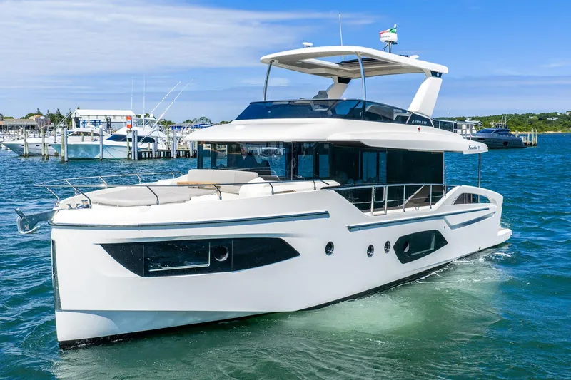 Slide: The Image of Luxury Absolute Navetta 53 yacht cruising in clear blue waters, 2026 model. - 4