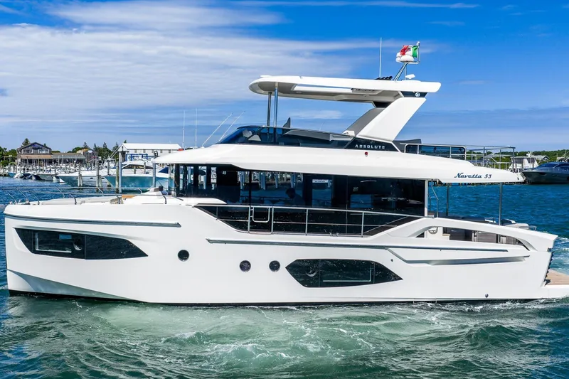 Slide: The Image of 2026 Absolute Navetta 53 yacht cruising in a marina under a clear blue sky. - 3