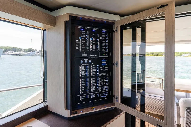 Slide: The Image of Electrical panel on Absolute Navetta 53 yacht, 2026 model, with scenic water view. - 16