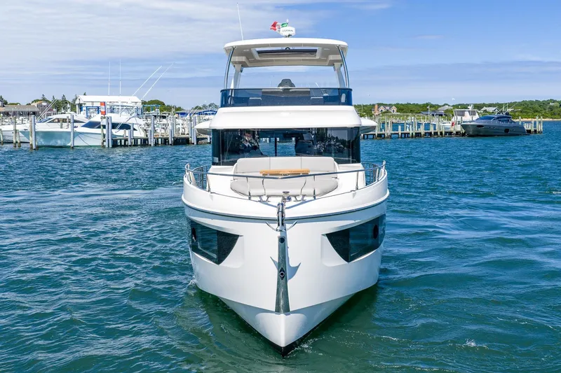 Slide: The Image of 2026 Absolute Navetta 53 yacht docked in a marina, showcasing sleek design and luxury. - 2