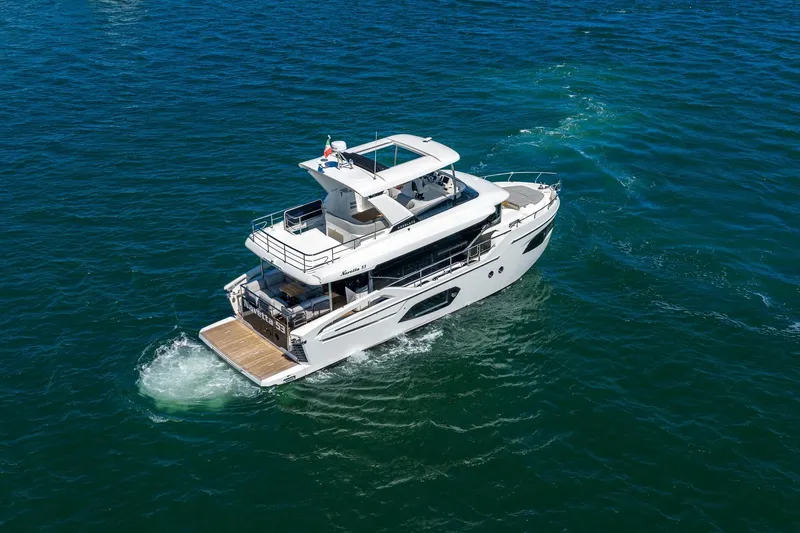 Slide: The Image of 2026 Absolute Navetta 53 yacht cruising on open blue waters. - 1