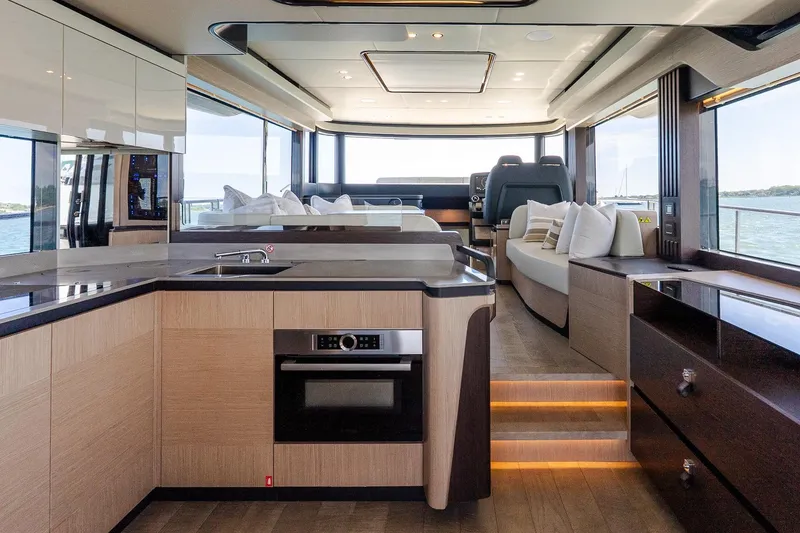 Slide: The Image of Luxurious interior of 2026 Absolute Navetta 53 yacht with modern kitchen and seating area. - 14