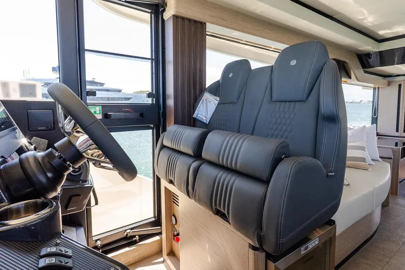 Slide: The Image of Luxurious interior of 2026 Absolute Navetta 53 yacht with plush seating and modern helm. - 22