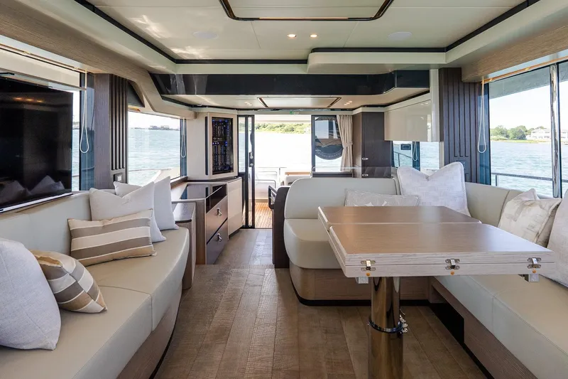 Slide: The Image of Luxurious interior of 2026 Absolute Navetta 53 yacht with elegant seating and dining area. - 17