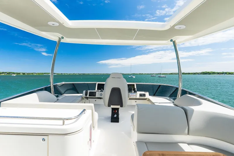 Slide: The Image of 2026 Absolute Navetta 53 yacht interior with ocean view, featuring modern seating and helm. - 51