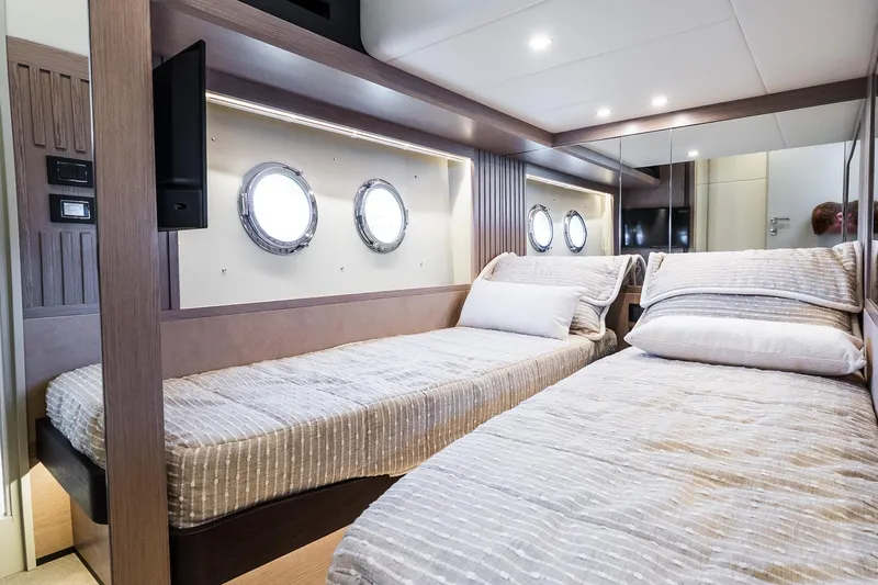 Slide: The Image of Twin cabin interior of 2026 Absolute Navetta 53 yacht with portholes and modern design. - 35