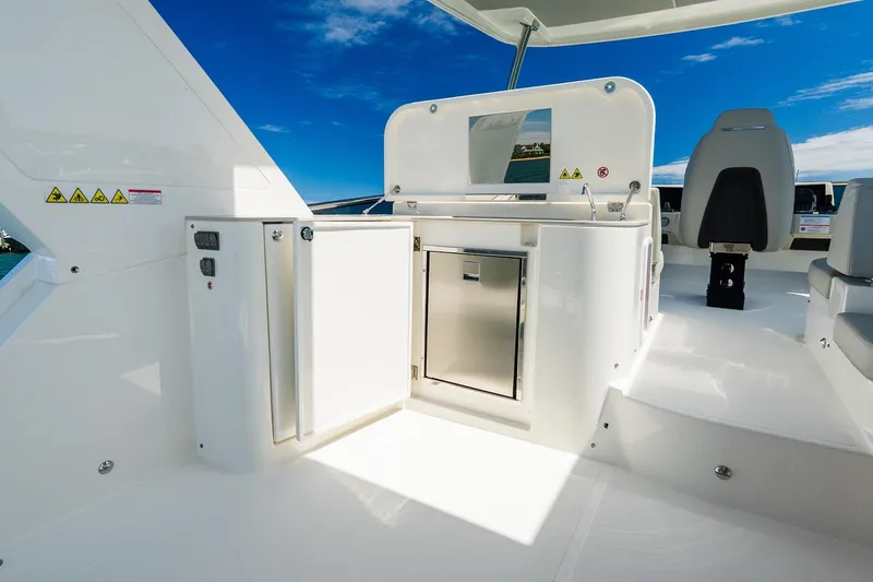 Slide: The Image of Luxury yacht Absolute Navetta 53, 2026 model, featuring sleek outdoor kitchen and seating area. - 49