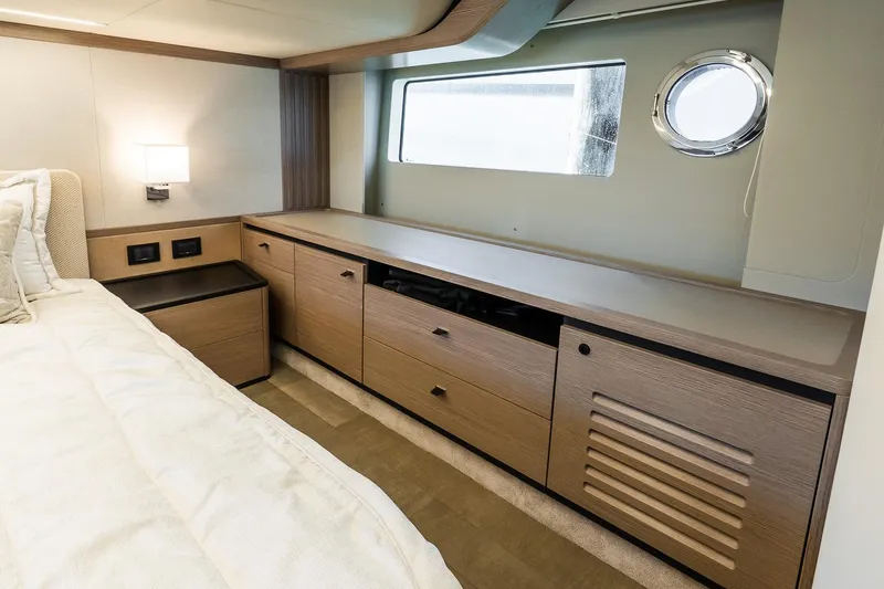 Slide: The Image of Luxurious interior of 2026 Absolute Navetta 53 yacht with modern wood cabinetry and bedding. - 33