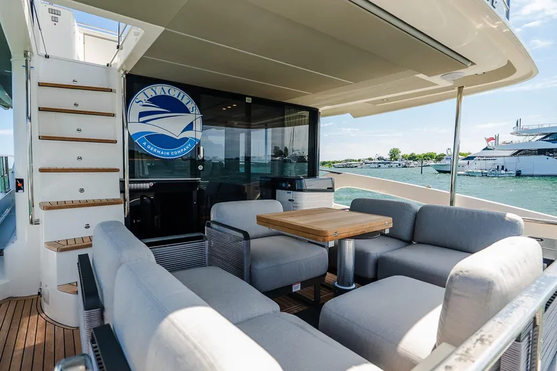 Slide: The Image of Luxurious 2026 Absolute Navetta 53 yacht deck with comfortable seating and scenic marina view. - 7