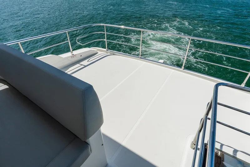 Slide: The Image of 2026 Absolute Navetta 53 yacht deck with railing, overlooking ocean waters. - 44