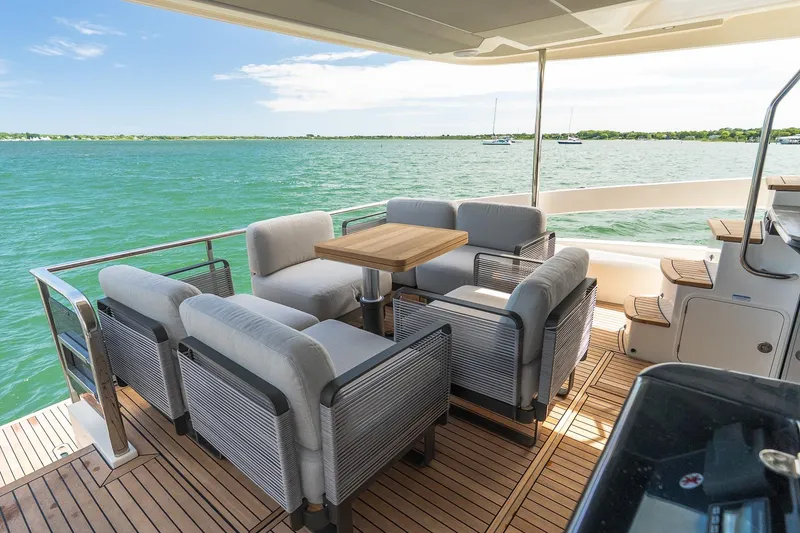 Slide: The Image of Luxurious outdoor seating on 2026 Absolute Navetta 53 yacht, overlooking serene ocean waters. - 11