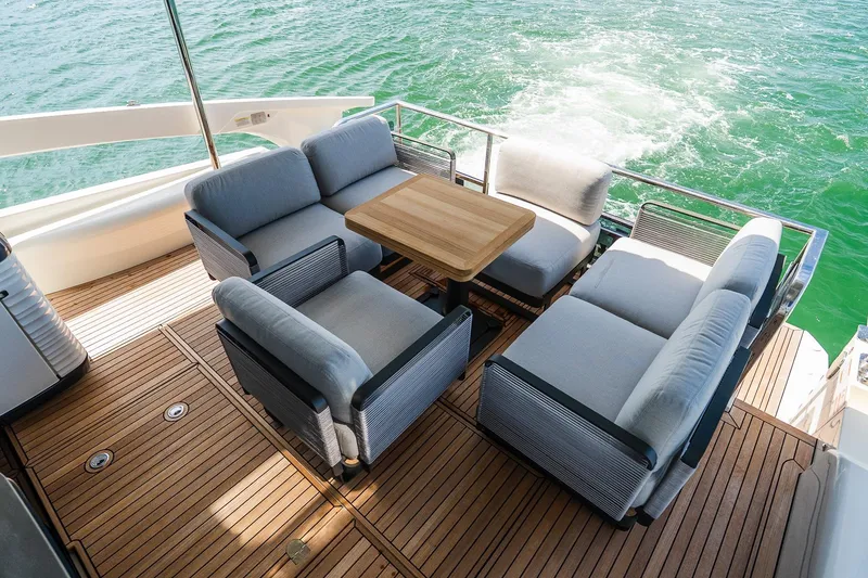 Slide: The Image of Luxurious 2026 Absolute Navetta 53 yacht deck with elegant seating and ocean view. - 12