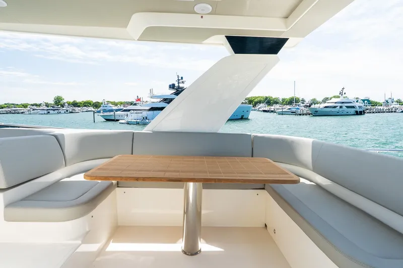 Slide: The Image of Luxurious seating area on 2026 Absolute Navetta 53 yacht, overlooking marina with multiple boats. - 47