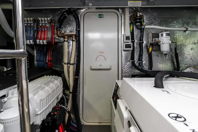 Slide: The Image of Engine room of 2026 Absolute Navetta 53 yacht with visible piping and machinery. - 62