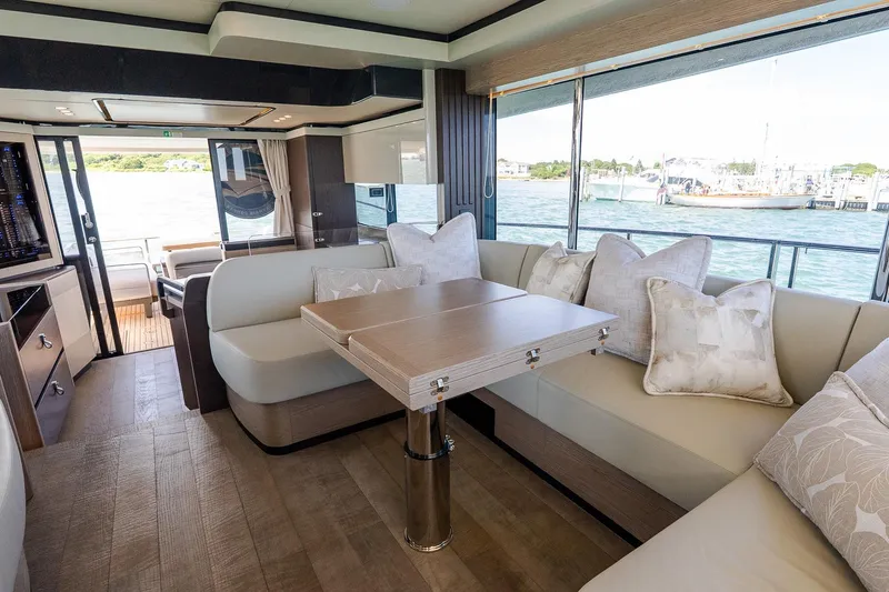 Slide: The Image of Luxurious interior of 2026 Absolute Navetta 53 yacht with elegant seating and scenic water views. - 19