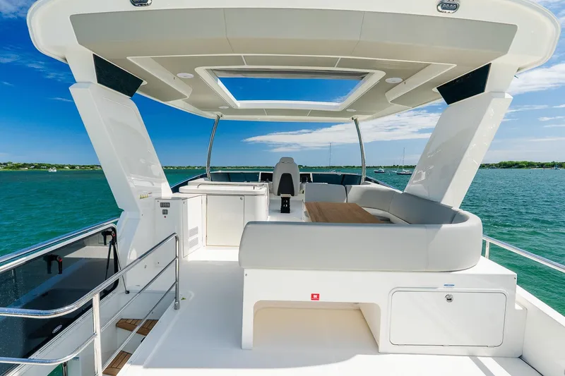 Slide: The Image of Luxurious 2026 Absolute Navetta 53 yacht deck with seating, overlooking serene blue waters. - 43