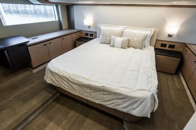Slide: The Image of Luxurious bedroom interior of 2026 Absolute Navetta 53 yacht with elegant bedding and wood accents. - 32