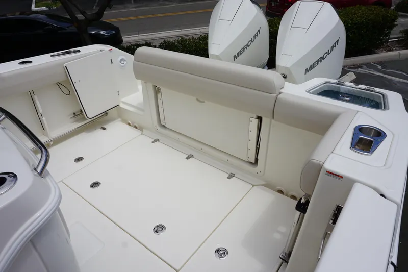 Slide: The Image of 2025 Boston Whaler 280 Outrage boat deck with dual Mercury engines, spacious seating, and storage. - 10