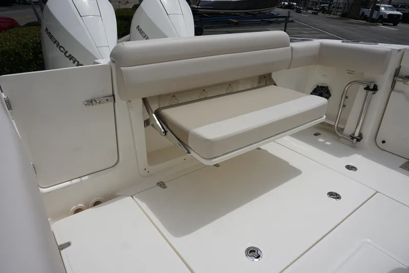 Slide: The Image of 2025 Boston Whaler 280 Outrage boat with foldable seating and dual Mercury outboard engines. - 15