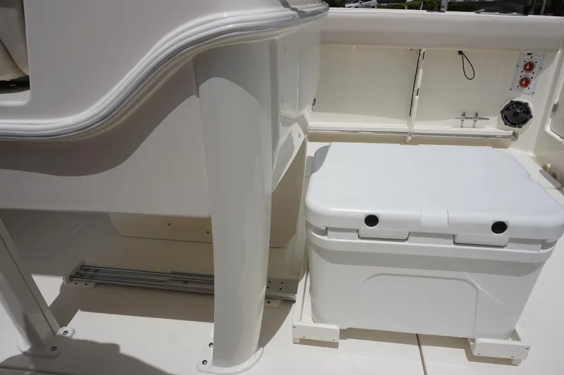 Slide: The Image of 2025 Boston Whaler 280 Outrage boat interior with storage compartment and cooler. - 16