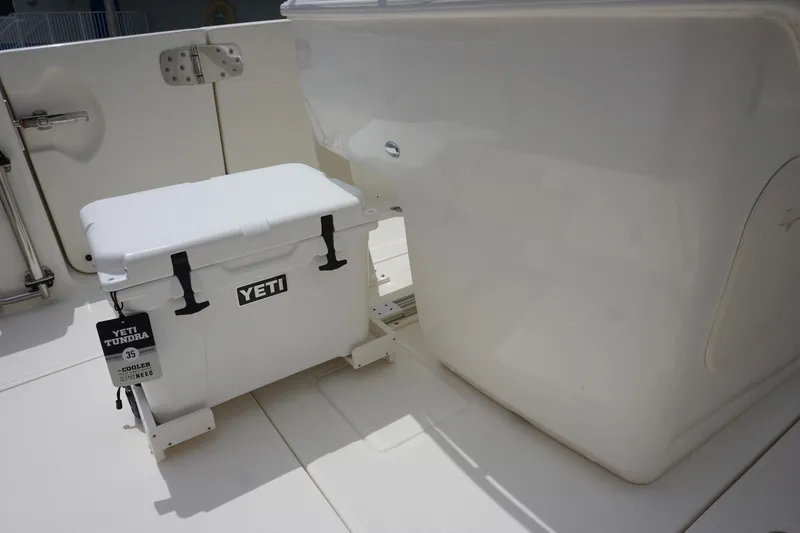 Slide: The Image of 2025 Boston Whaler 280 Outrage deck with Yeti cooler, showcasing sleek design and functionality. - 17
