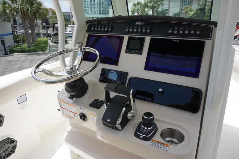 Slide: The Image of 2025 Boston Whaler 280 Outrage helm with advanced navigation and control systems. - 20