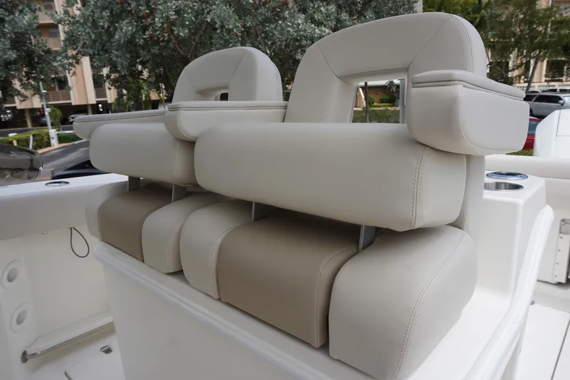 Slide: The Image of 2025 Boston Whaler 280 Outrage boat seats, featuring plush beige upholstery. - 26