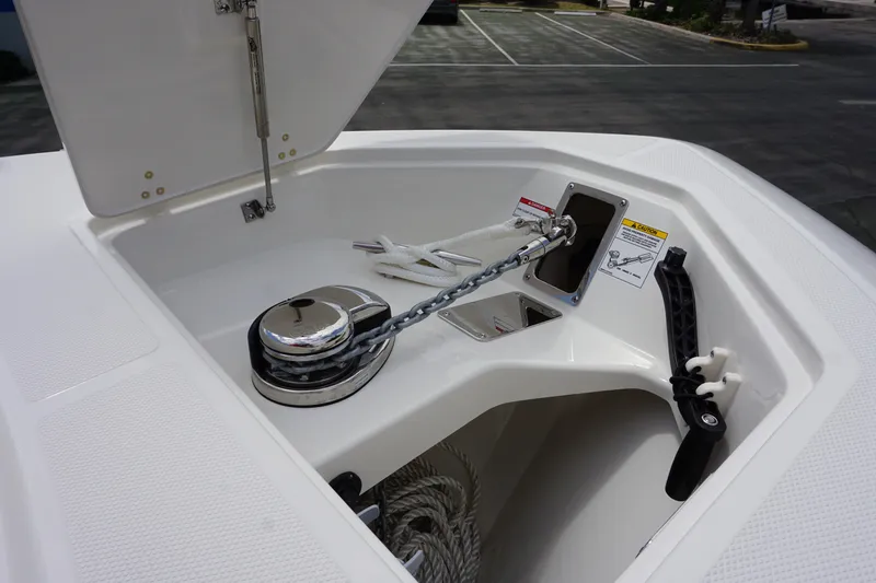 Slide: The Image of 2025 Boston Whaler 280 Outrage anchor compartment with chain and winch system. - 31