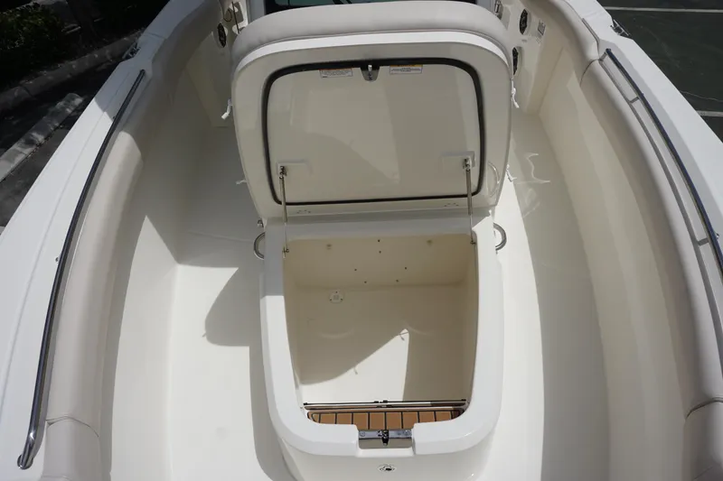 Slide: The Image of 2025 Boston Whaler 280 Outrage boat with open storage compartment. - 36