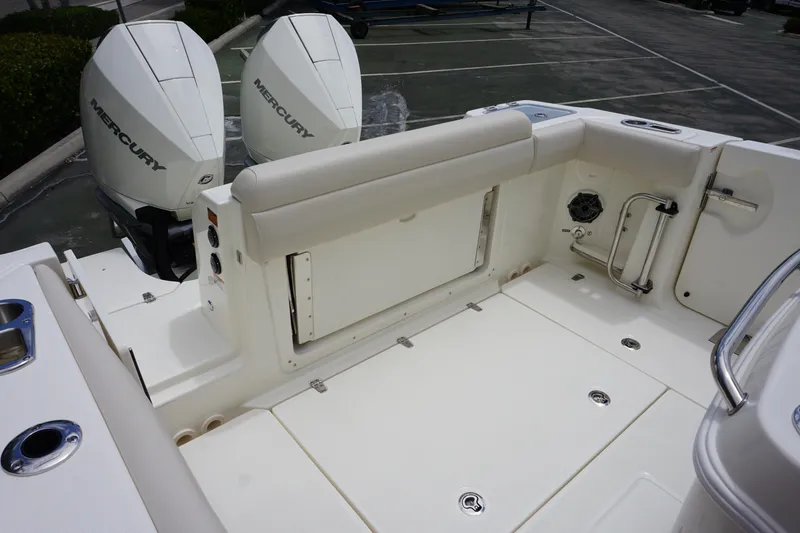 Slide: The Image of 2025 Boston Whaler 280 Outrage boat deck with twin Mercury engines, featuring spacious seating. - 9