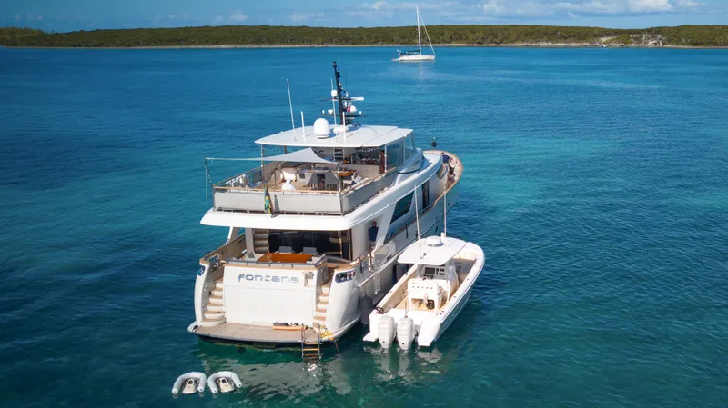 Slide: The Image of Sanlorenzo SD92 2012 yacht anchored in clear blue waters, with a tender alongside. - 12