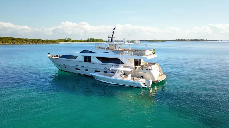 Slide: The Image of Sanlorenzo SD92 2012 yacht anchored in clear blue waters, with a small boat nearby. - 13