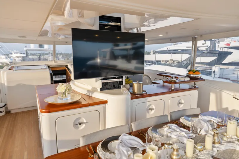 Slide: The Image of Luxurious 2012 Sanlorenzo SD92 yacht interior with elegant dining setup and large TV screen. - 16