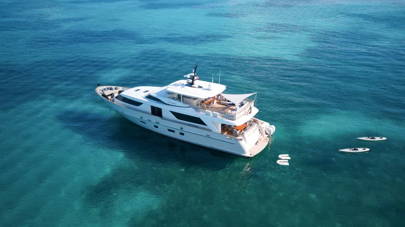 Slide: The Image of Sanlorenzo SD92 yacht from 2012 on clear turquoise water, with paddleboards nearby. - 4