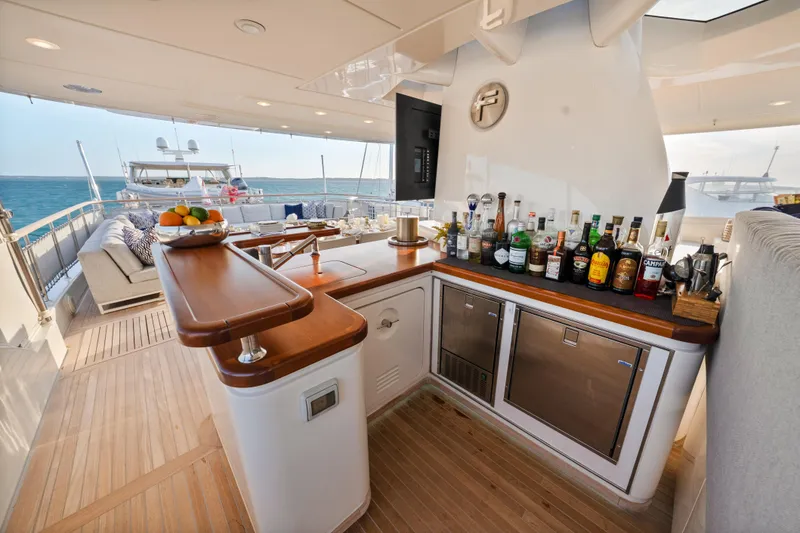 Slide: The Image of Luxurious Sanlorenzo SD92 yacht deck with bar, featuring drinks and ocean view, 2012 model. - 41