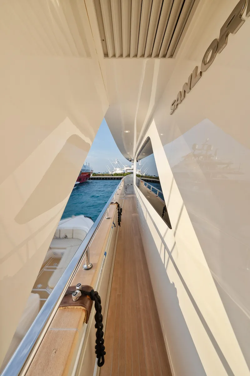Slide: The Image of Side deck view of 2012 Sanlorenzo SD92 yacht, showcasing sleek design and ocean backdrop. - 46