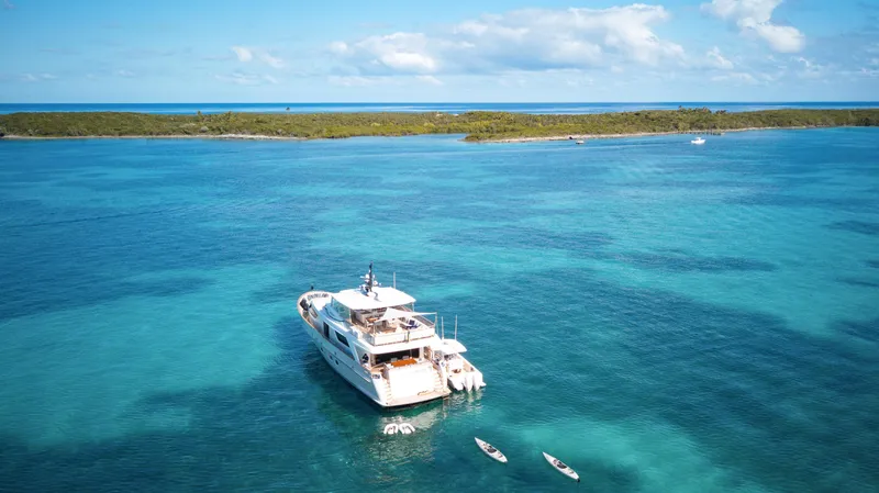 Slide: The Image of Sanlorenzo SD92 yacht from 2012 on clear blue waters, with scenic island backdrop. - 5