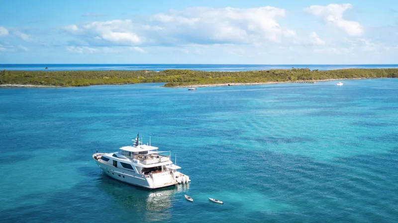 Slide: The Image of Sanlorenzo SD92 yacht from 2012 anchored in clear blue waters near a lush island. - 6
