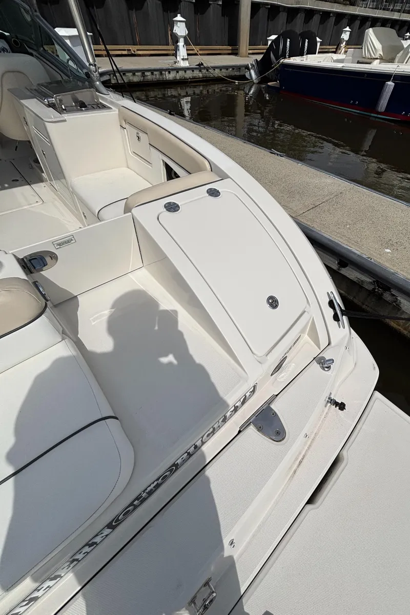 Slide: The Image of 2008 Sea Ray 290 Sundeck boat docked, featuring spacious seating and sleek design. - 14