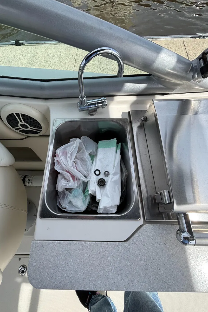 Slide: The Image of Sink area on a 2008 Sea Ray 290 Sundeck boat with faucet and storage. - 40